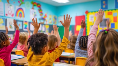 First-grade classroom with children raising their hands to answer questions, filled with colorful decorations and engaged young students.